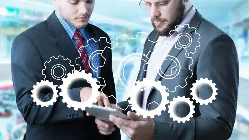 lean-manufacturing-gestores-de-terno-e-gravata-juntos-com-tablet-nas-maos-e-engrenagens-de-inteligencia-artificial