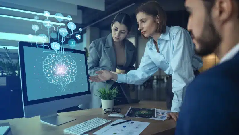 o-que-e-inteligencia-artificial-duas-mulheres-e-um-homem-olhando-para-tela-do-computador-em-um-escritorio