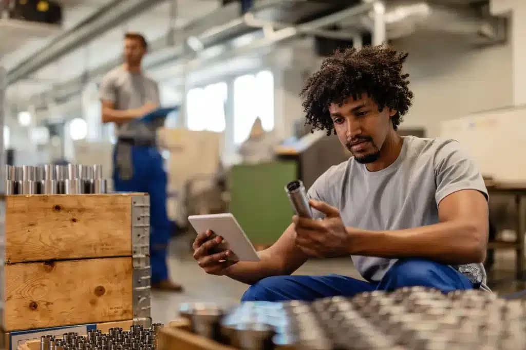 neoindustrializacao-trabalhador-manual-usando-o-touchpad-ao-examinar-hastes-de-aco-inoxidavel-fabricadas-em-uma-fabrica