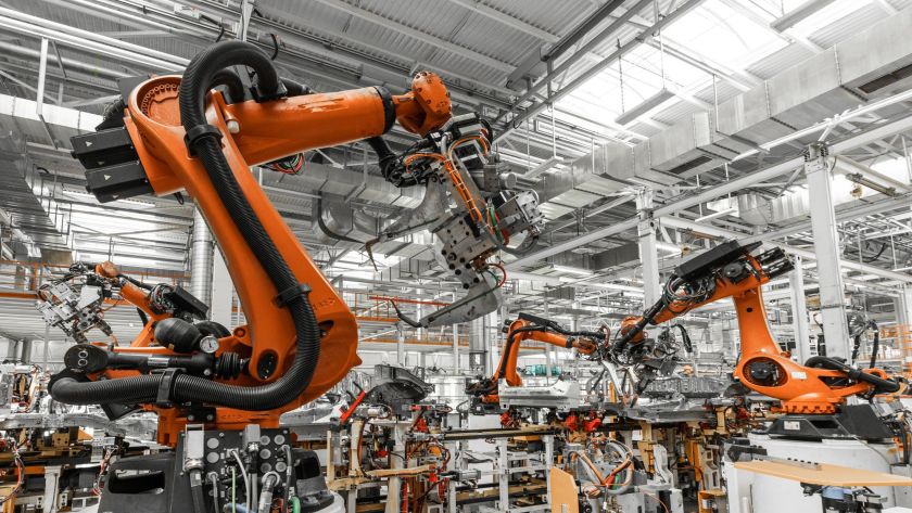 A imagem mostra um sistema avançado de robôs industriais, conhecidos como "pick-and-place", que são utilizados para realizar tarefas de movimentação de peças em linhas de produção automatizadas. Esses robôs são projetados para pegar, transportar e posicionar componentes com alta precisão, otimizando processos na indústria.